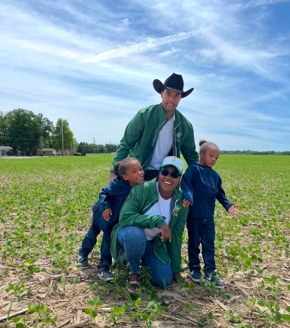 The Johnson family of Goode Foods in a young soybean field on a partner farm
